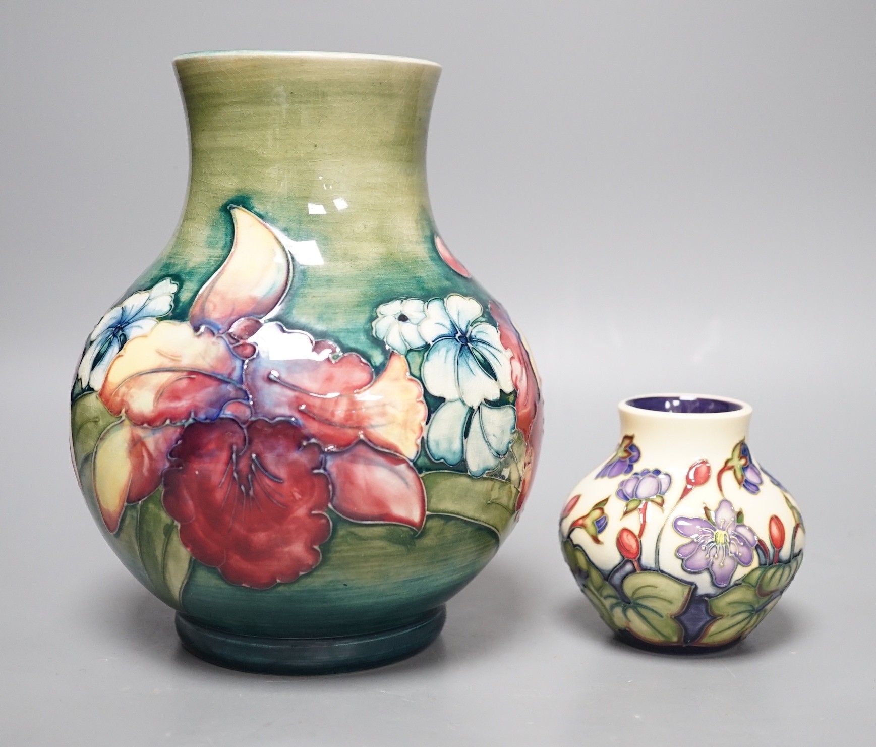 A Moorcroft orchid pattern vase and another smaller vase, orchid vase 19cms high